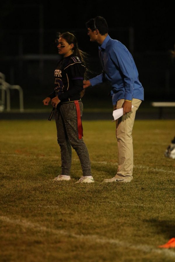Bobbi Lima being coached by Sage McMinn for the next play against the Juniors in the Powder Puff football game.