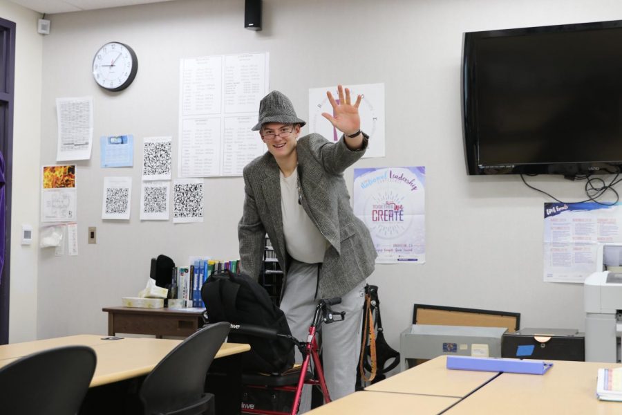 Senior Scott Tatum waves hello from his Intro to Law class on Thursday, Feb. 13.  Tatum is dressed up for tonight's 