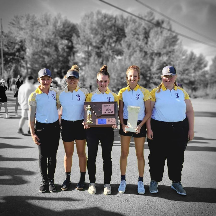 Members of the girls golf team hold the third place trophy at the state tournament in Polson.