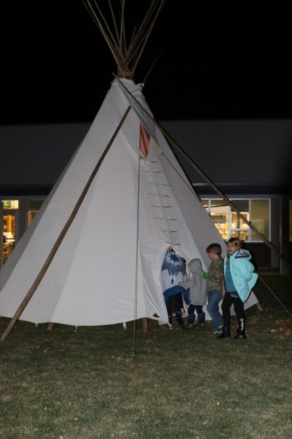 Staff and their family enter the tipi in the courtyard during the staff feed on Nov. 19.