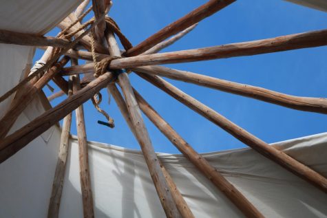 Looking out the center of the tipi, it is apparent how the poles are arranged to allow smoke to escape.