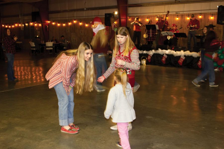 Ava Malone and Mayzee Blakesley-Robinson dance around with the little ones at the Park High Rodeo Club Cowboy dance. 