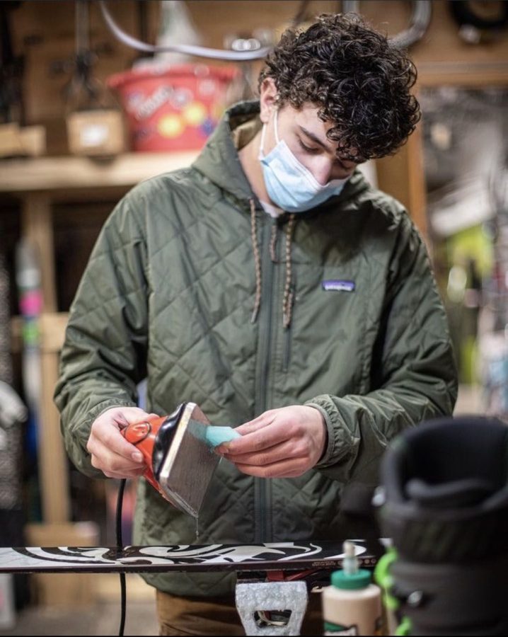 Senior Simon Bishop is waxing skis to get ready for the busy season, while working at Dan Bailey's.