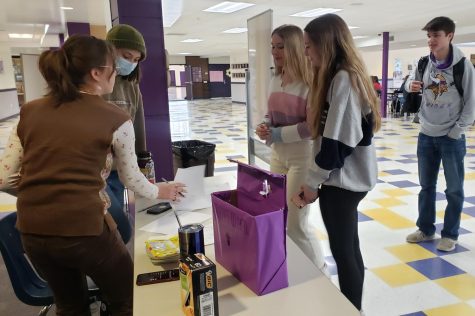 Sophomores Ella Wood and Alphia Fanuzzi cast their votes for student council president during lunch on Monday.