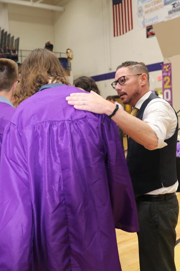 World Languages teacher Daniel McGrath shares a moment with senior Logan Sites after placing his graduation robe on him.  This year, valedictorians and salutatorians chose a staff member to participate in the robing ceremony during graduation.