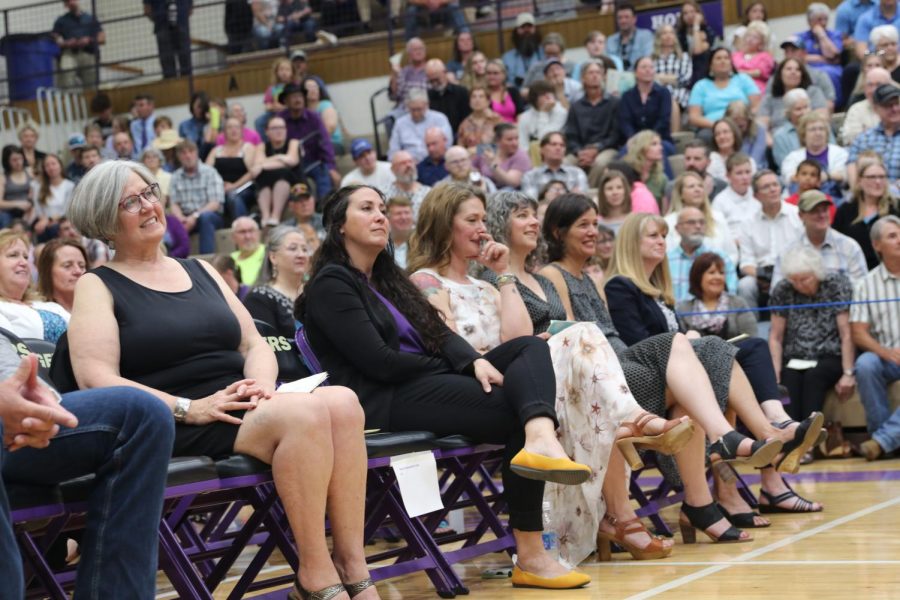 Teachers look on during the graduation ceremony, including several elementary teachers who were invited to robe the valedictorians.