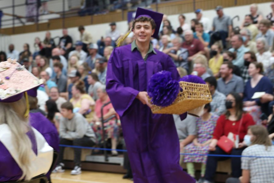 Simon Bishop clutches the basket he took from the stage, which Principal Dust was using to hold all the golf balls seniors handed her as they shook her hand.