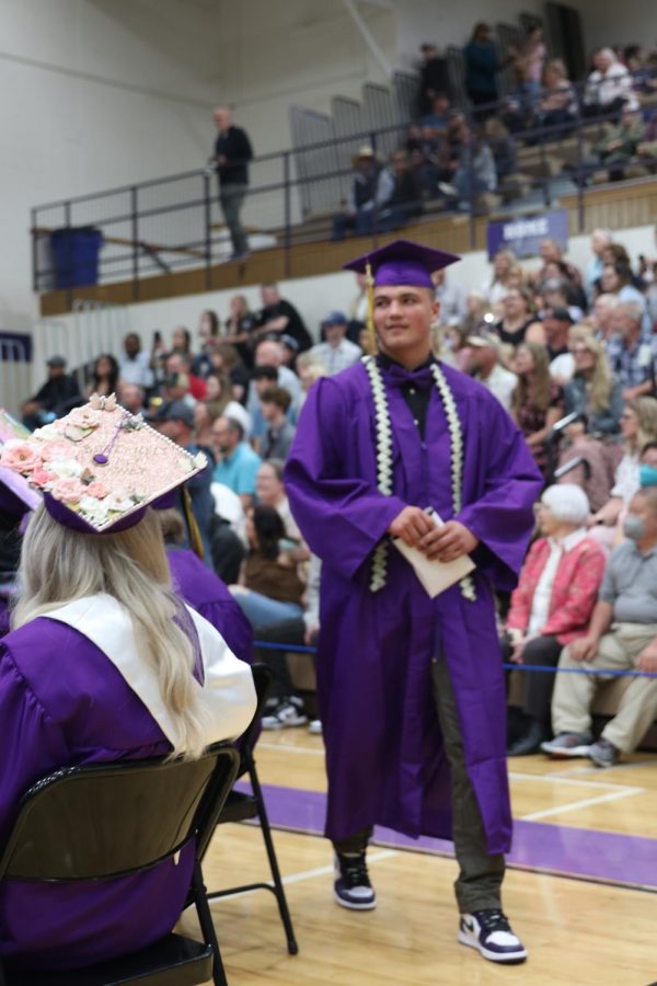 Cade Gubler returns to his seat after receiving his diploma.