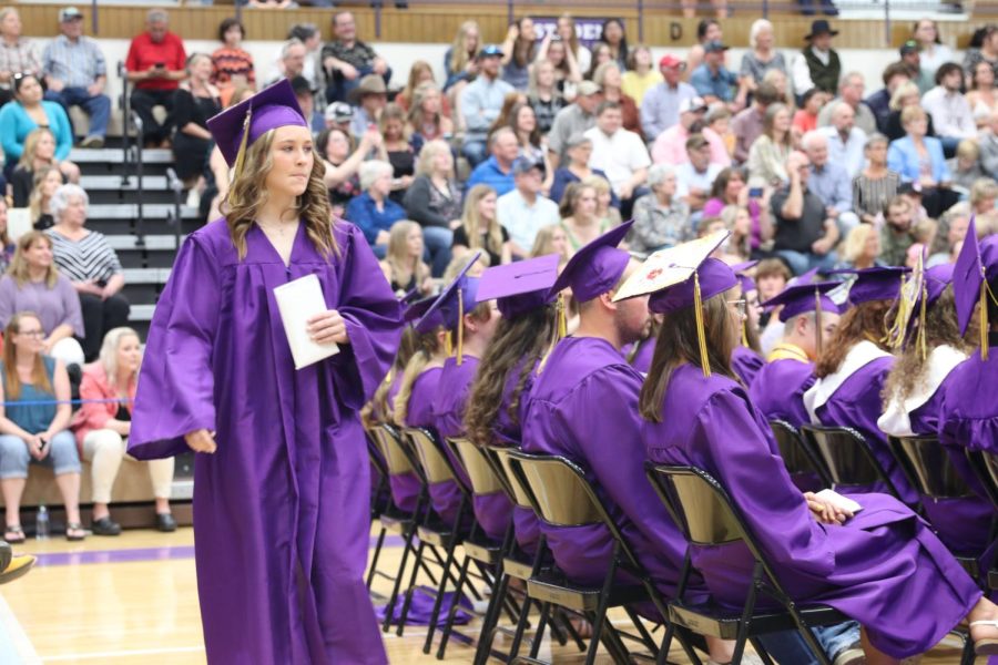 Megan Shannon clutches her diploma after walking across the stage to graduate.
