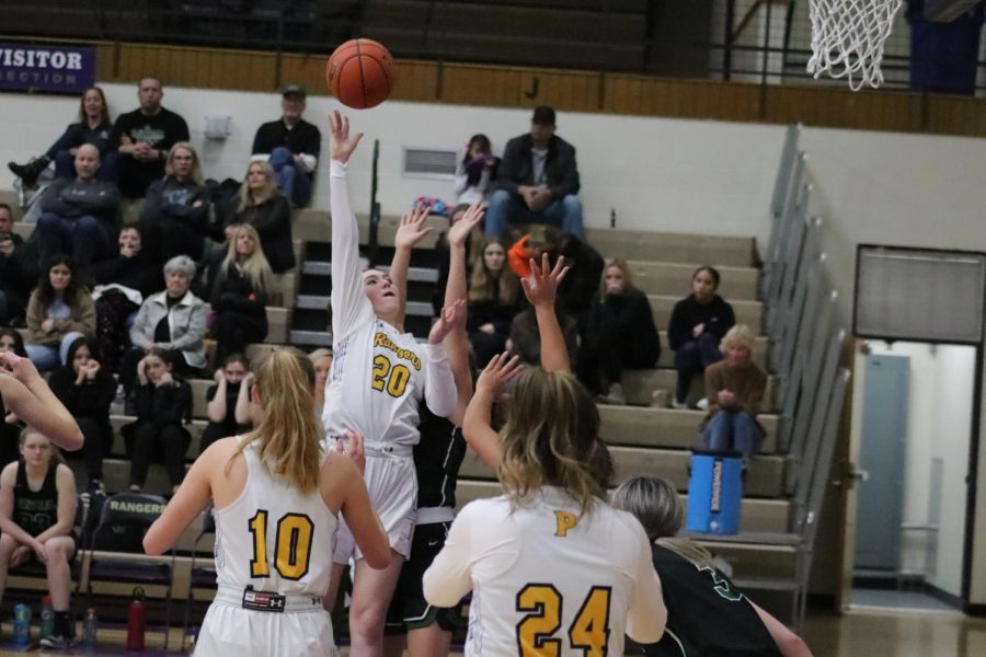 Maria Turck taking a hook shot over a Billings Central Defender while Veronica Glenn and Alivia Duffy get into rebounding positions.