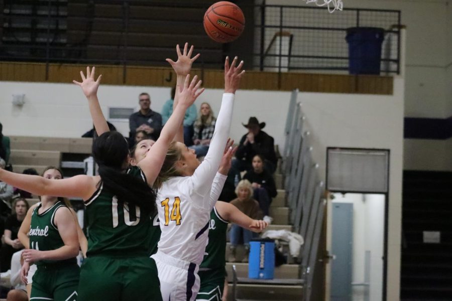 Zoey Payne going up for the shot through two Billings Central defenders