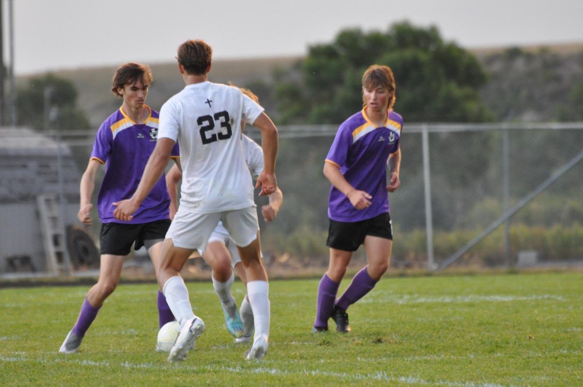 Oliver Bauman and Silas Hjortsberg defend against a Billings Central player in the Sept. 7 home game.