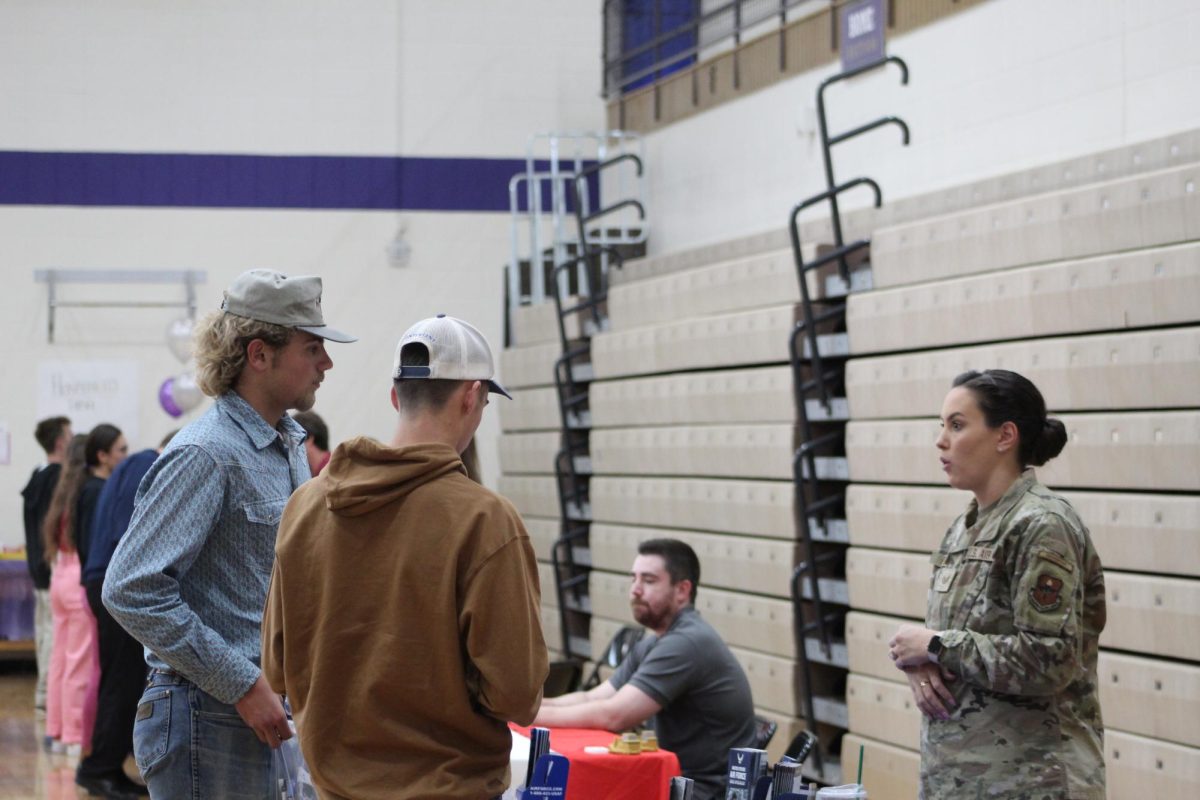 Seniors Brooks Smith and Paul OHair speak with a representative at the military booth.