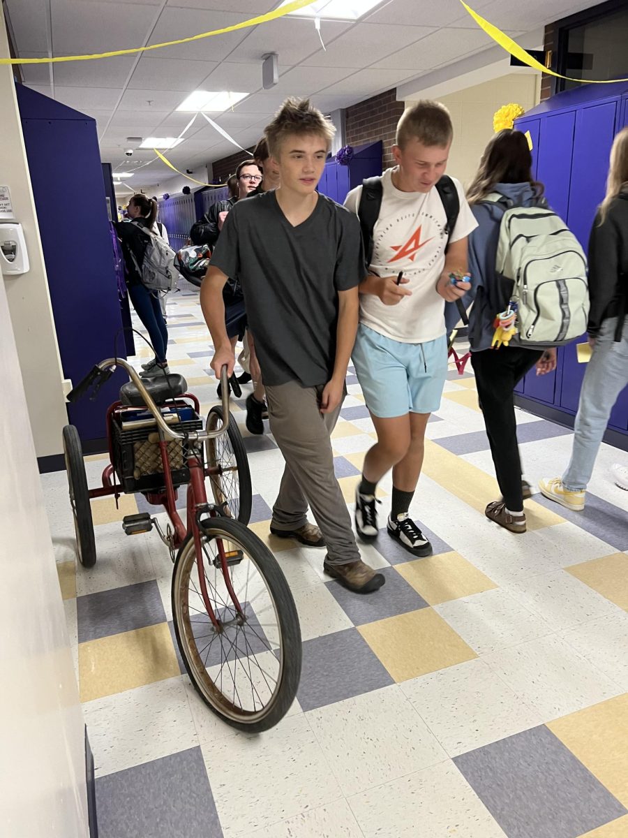 Bike-pack: Sophomore Sean Gadberry pushes his bike through the halls Tuesday morning before school, using the basket to stow his books.  Former science teacher David Pettit gave him the bike in seventh grade, Gadberry said.  Ben Bandstra didnt participate in the Homecoming Anything but a Backpack day, choosing instead to carry his books in a backpack.