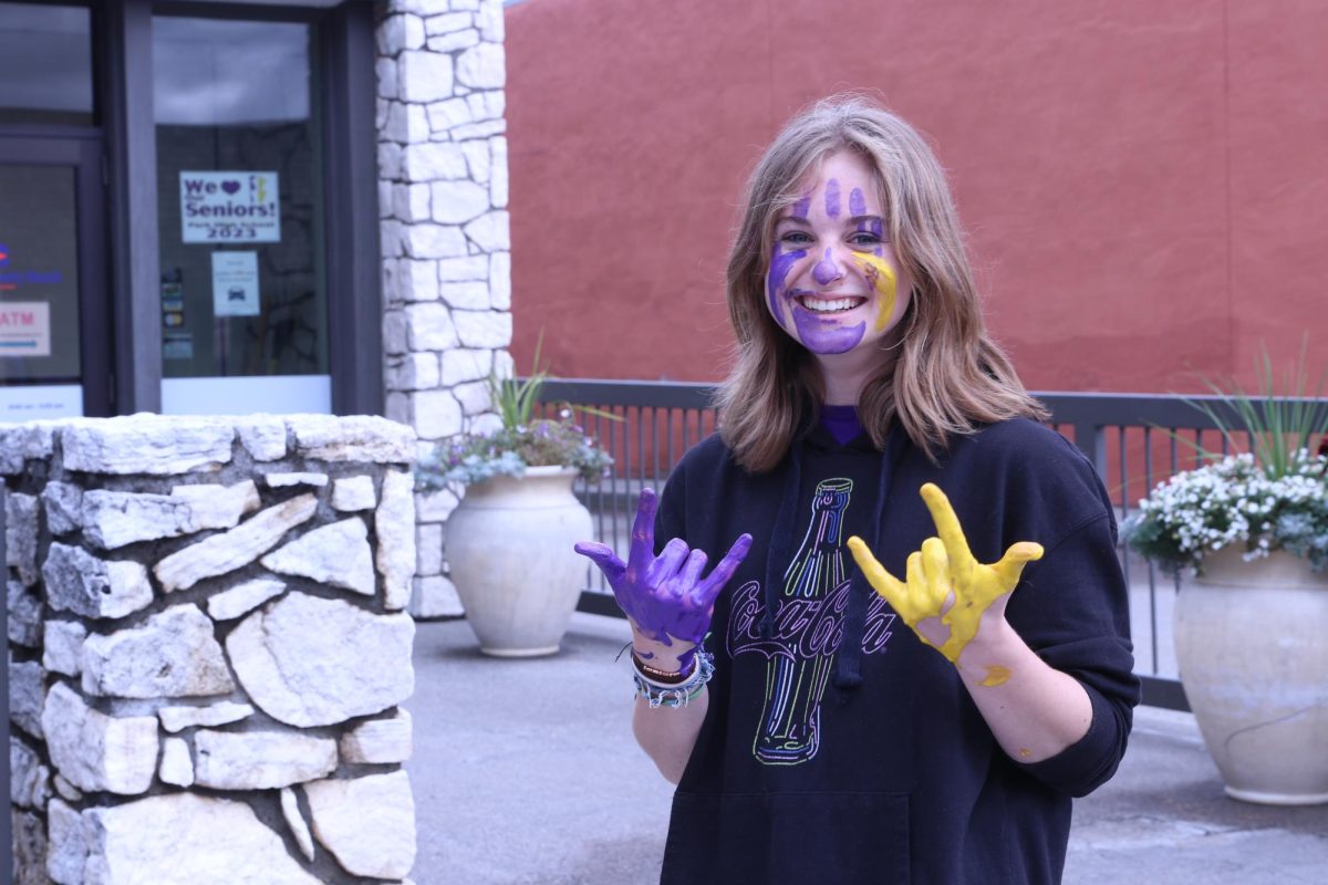 Sophomore+Ellie+Ames+helped+paint+the+town+purple+for+Homecoming.