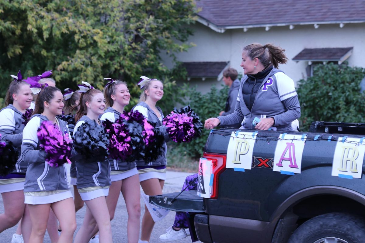 Park High cheerleaders follow behind assistant cheer coach Hannah Sexton.