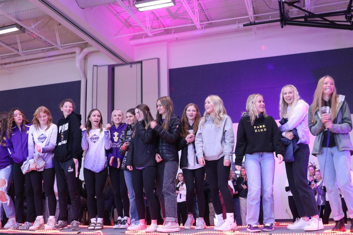 The volleyball team gathers on stage during the pep rally and played their homecoming games against Lockwood on Saturday.