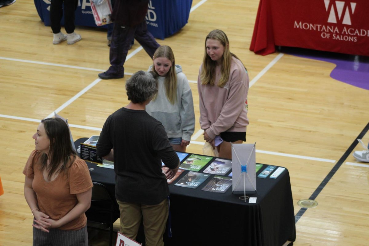 Hailey Tuccillo and Tess Cocotos visit a booth at the Montana College Fair at Park High School on Monday September 18