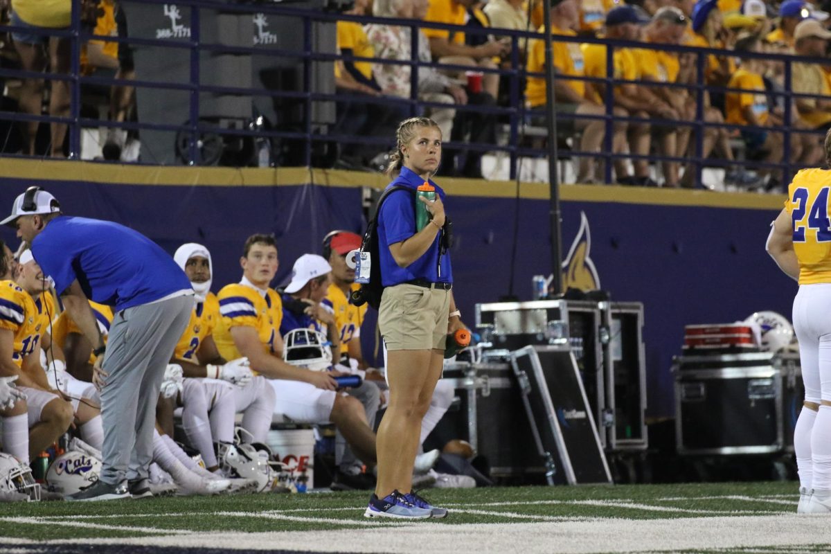 Cheyenne Hanks, Athletics Trainer, assisting at Montana State University football game.