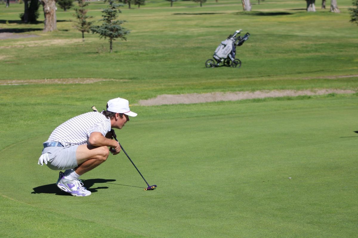 Senior Houston Dunn reads a putt at the first golf tournament of the season in Butte.  