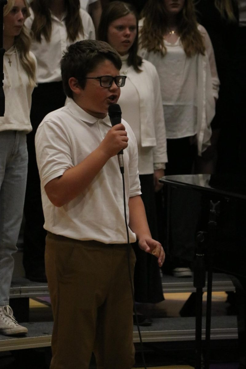 Seventh grader Max Olsen sings a solo during Twist and Shout.