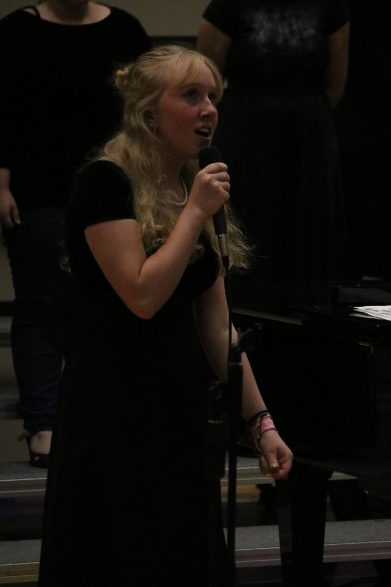 Elaine Petersen sings a solo during These Boots Were Made For Walking in the Concert Choir portion of the evening.