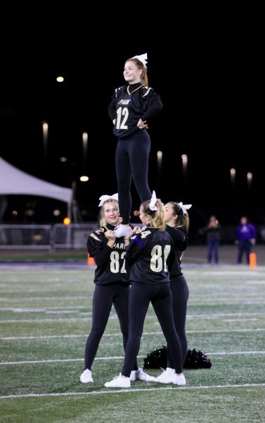 Savanah Burns is supported by fellow senior cheerleaders during the half time performance at MSU Stadium, October 6, 2023.