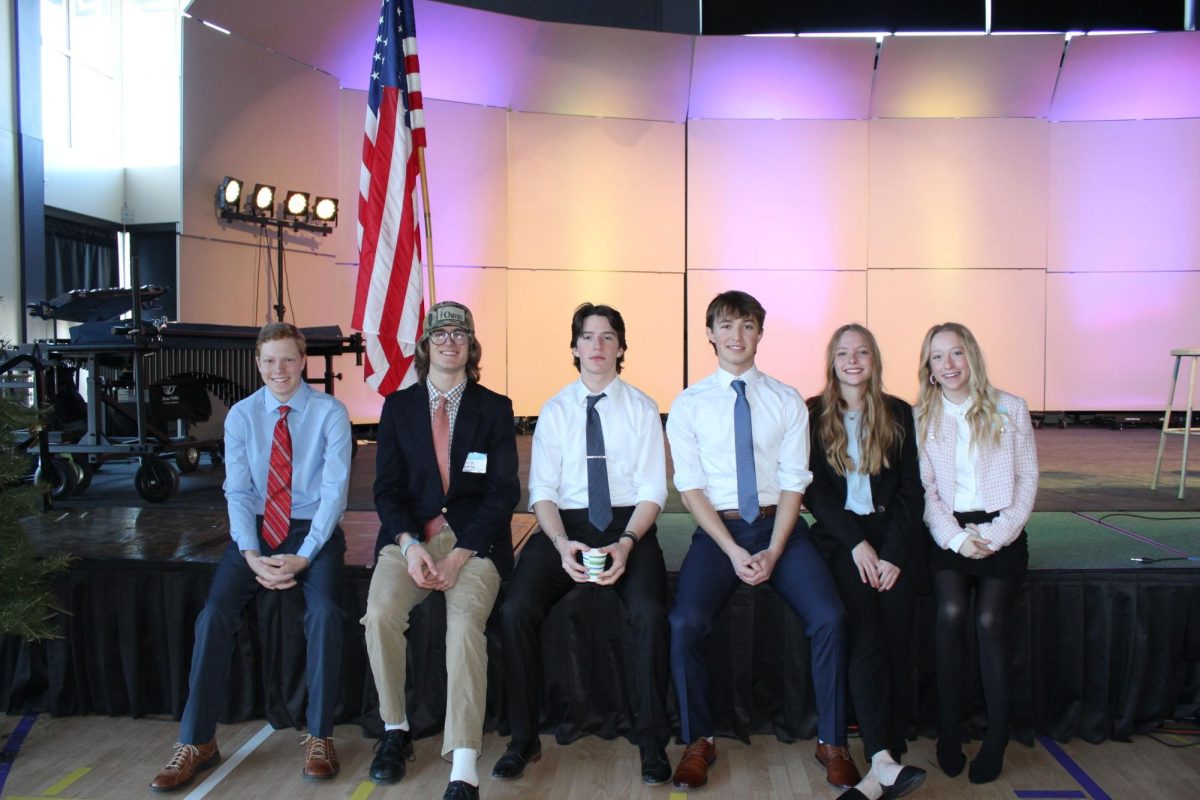 Members of the Park High BPA chapter relax on the stage after awards were given at BPA Regionals in December.