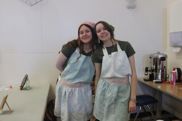 Senior Katia Logan and Junior Grace Fish stand cheerfully after making some hot drinks for the Thirsty Fish