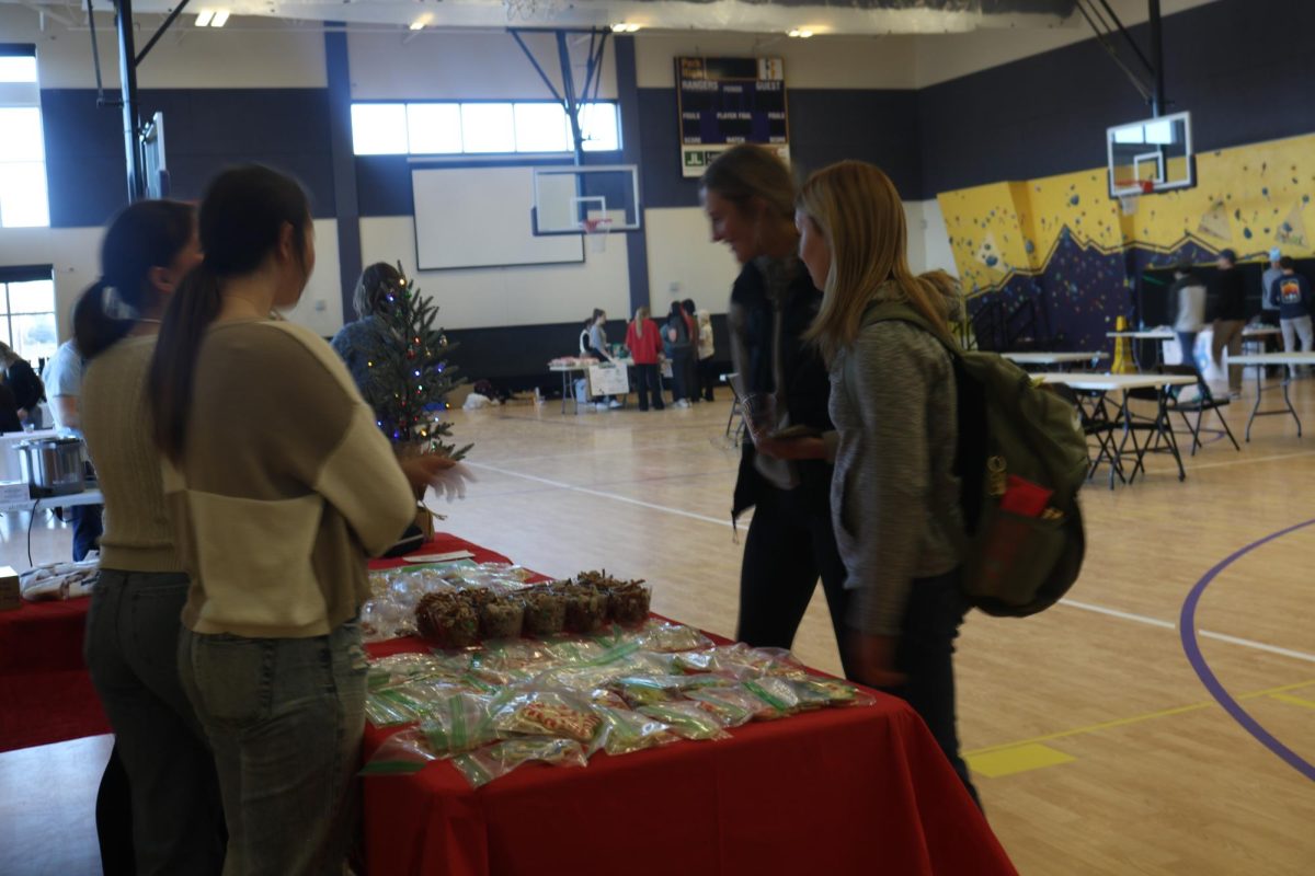 Seniors Zoey Payne and Megan Otis look at the different snack options available at Santas Snack Shop 