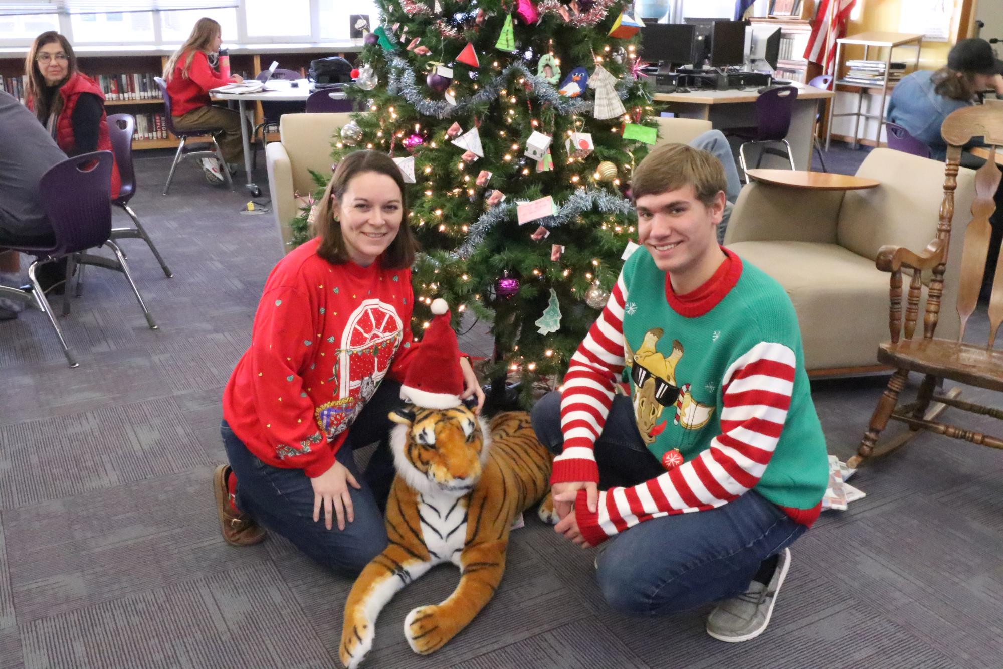 Library aid and student body president Willam Tyner and Mrs. Lende pose with the Christmas tiger after his traumatic experience of attempted tiger napping via an unknown eighth-grader.