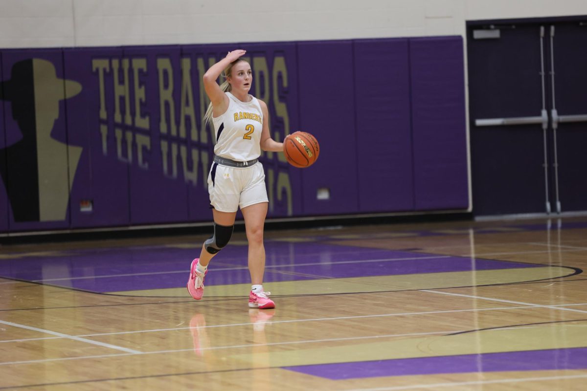 Maya Stenseth, Senior calls out a play while dribbling down the court.