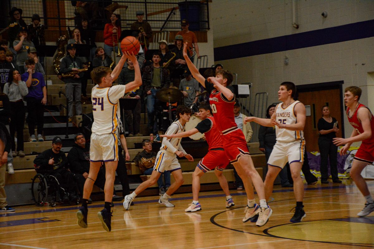 Junior Tristan Watts shoots a contested three. Watts and the Rangers faced the Lions on February 10th.