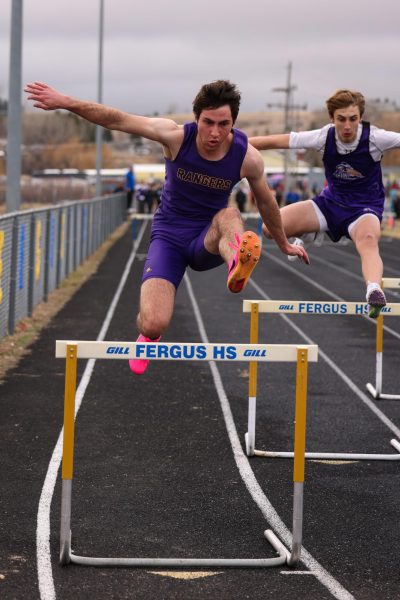 Junior Morgan Sites charges over a gate in the 300 meter hurdles.