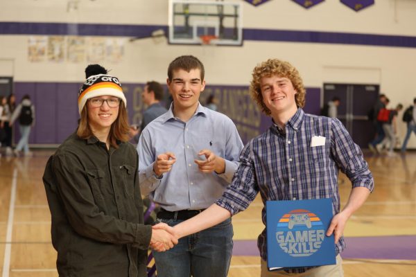 Candidates for student council president, Augie Stern and Jon Durgan, shake hands after the assembly, while Durgans VP running mate, Stacy Sundling, stands between them.