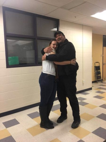 Dann Babcox hugs his daughter Danielle in the halls of Park High, where she attended school.