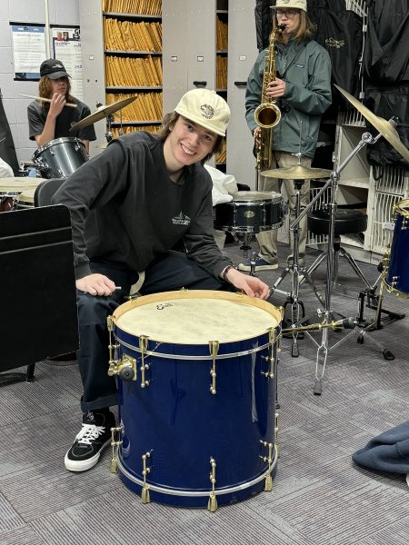 Brinley Halland practices on the drums in the band room.