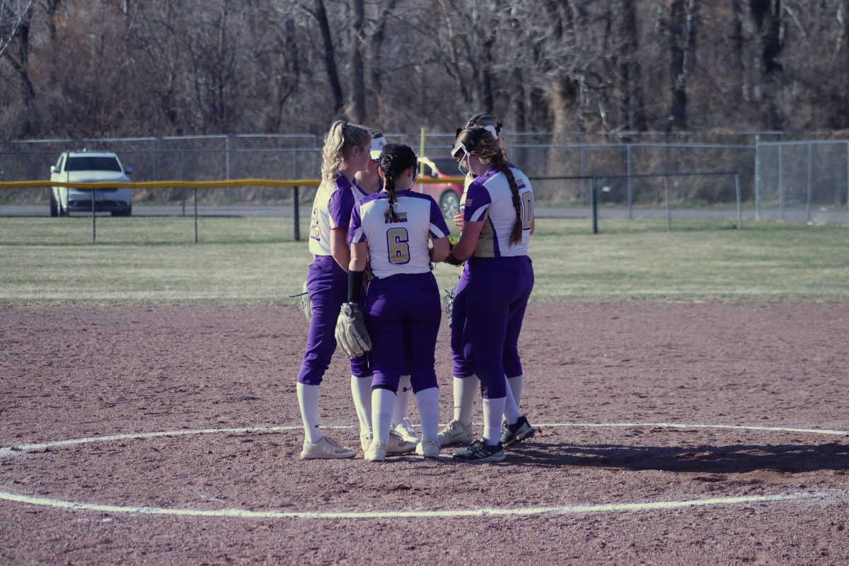 The Lady Rangers come together at the pitchers circle to start the inning.
