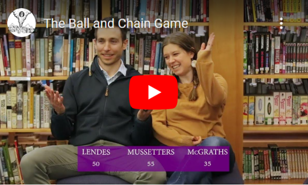 Three teacher couples compete in the Ball and Chain Game