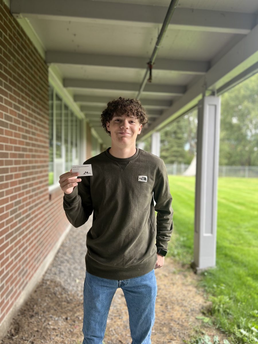 Noah Craig holds up one of his new business cards for Alpine Range Photography.  The junior has been developing his photography skills for several years and hopes to turn his talents into a profitable business.