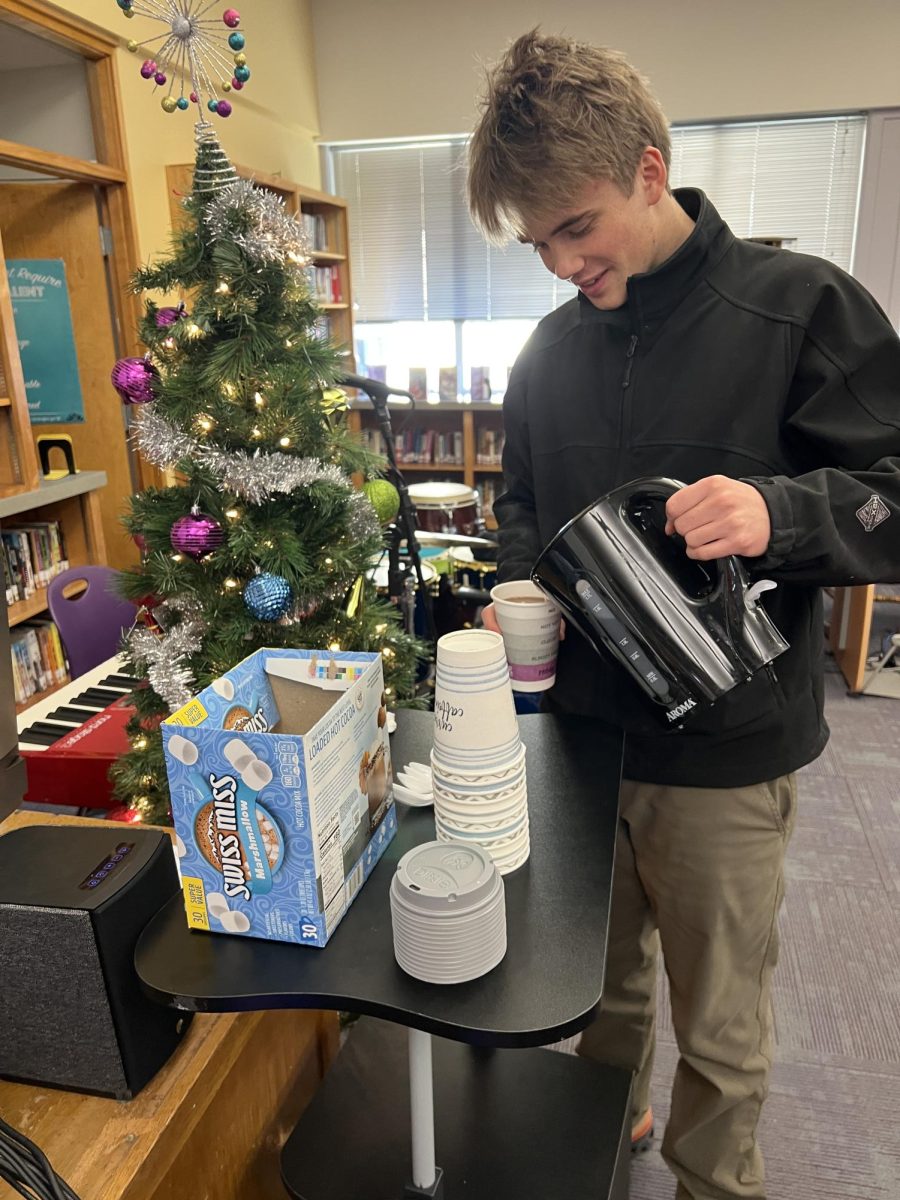 Junior Sean Gadberry pours himself some hot cocoa at lunch.