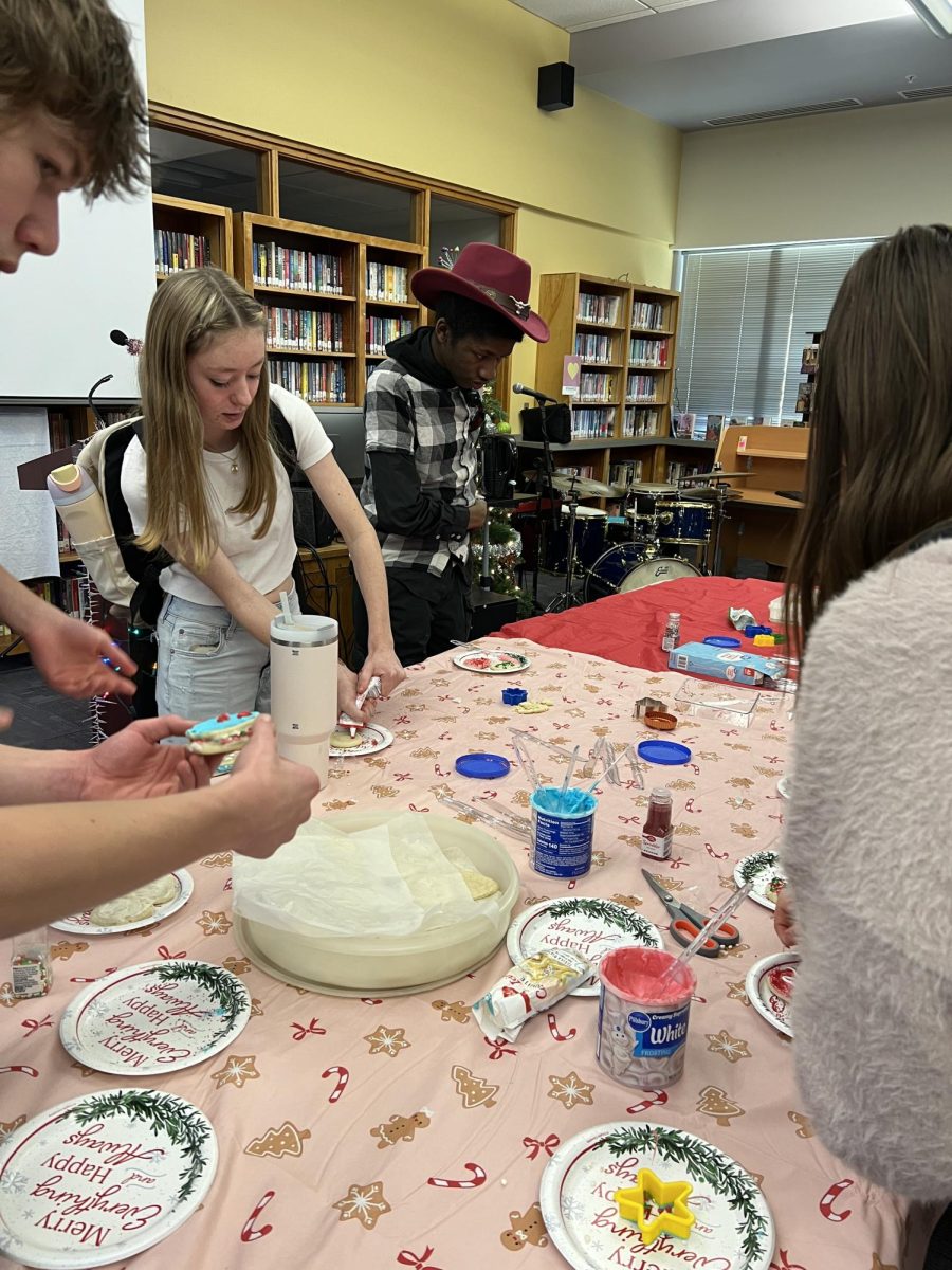 Jackson Greisen, Ella Mendez and Prince Ludaway decorate cookies in the library during lunchtime.