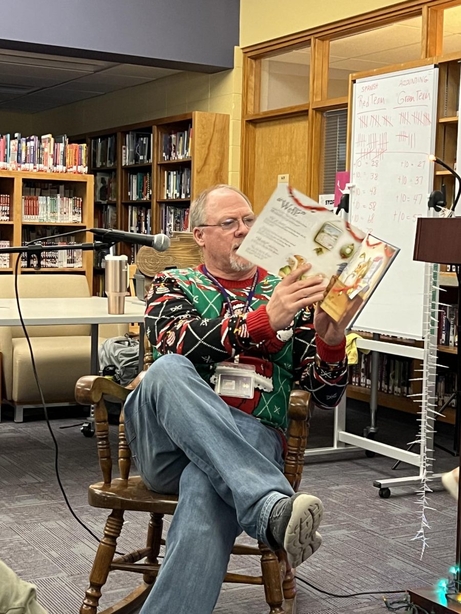 Park High Principal Cole Maxwell reads the picture book, "Santa Comes to Montana" to the audience of students and teachers seventh period in the library.