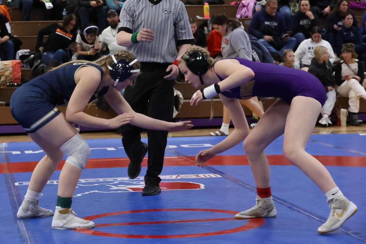 Samantha Stanbary, 10th grade, stares her opponent down before she wrestles.
