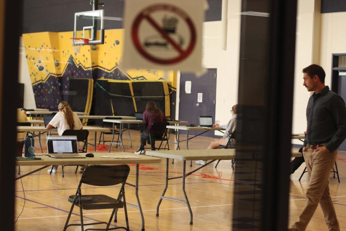 Teacher Andrew Marsh proctors an AP practice test in the Rec Plex.  Many standardized exams are now entirely online, increasing the demand for reliable devices.