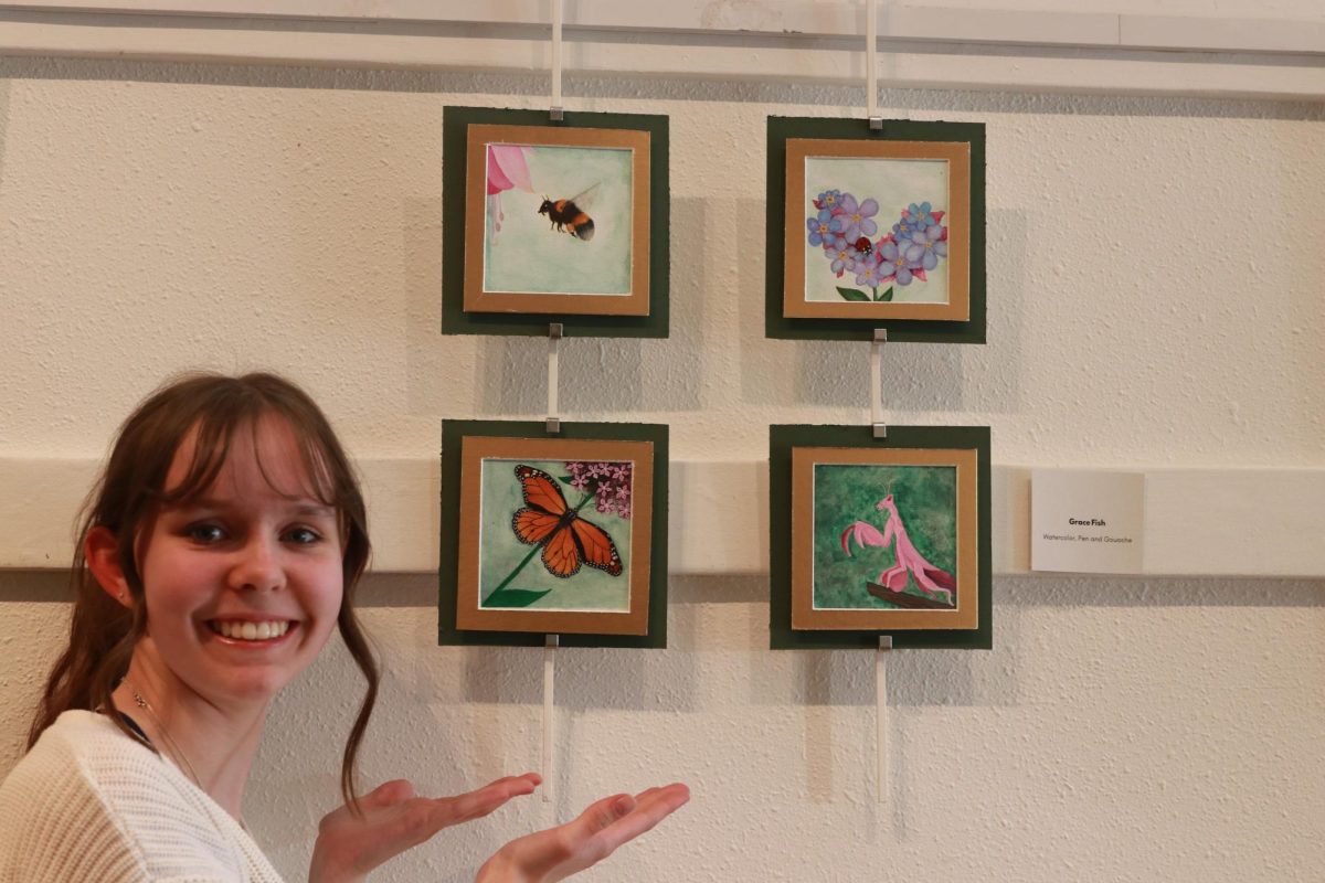 Grace Fish with her painting. Her piece was made with water colors, pen, and gouache. Art teacher Sarah Mussetter said about Fish: "she stared to take more risks this year. She tried gouache for the first time this year."