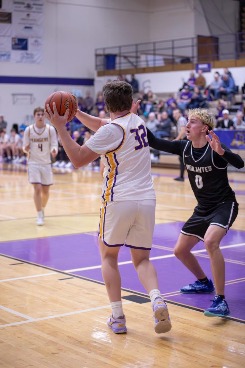 Senior center Lliam Edwards looks to pass to teammate Weston Vincent during the game against East Helena.  "We came out with good intensity in the first half," Edwards said.