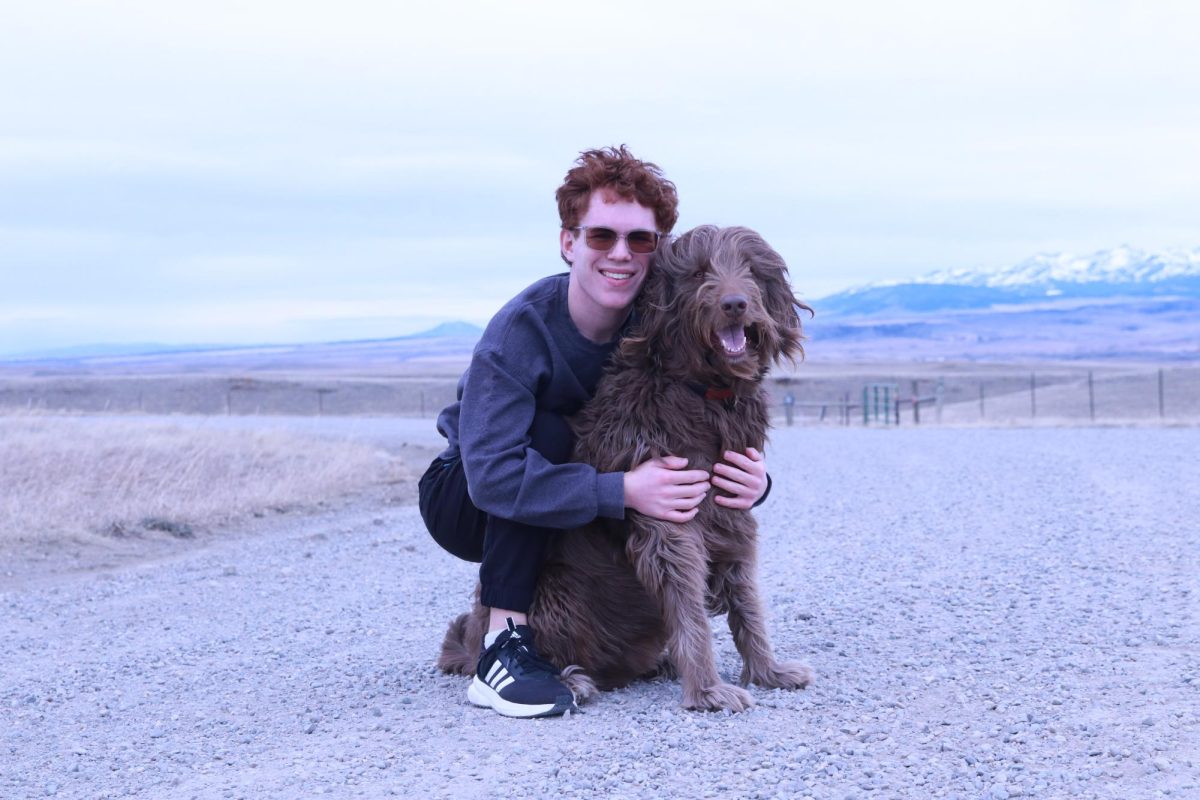 Enjoying a beautiful walk in the Montana Mountains with a special animal companion taking in the scenic dirt roads and the sky scaping mountains.   