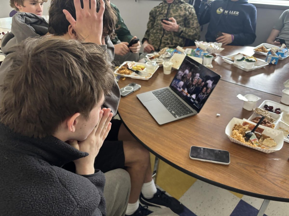 Seniors Coen Braham and Isaac Ramirez recreate a picture of them watching Furman's buzzer beater win during Earth Science class when they were freshman.